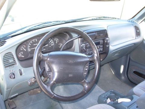 1997 Ford Explorer - The interior of a 1997 Ford Explorer, showing the dashboard, steering wheel, and center console.