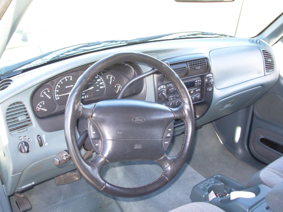 Interior view of 1997 Ford Explorer dashboard with steering wheel and gauges