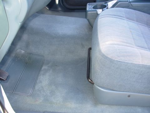1997 Ford Explorer - Interior view of a 1997 Ford Explorer, focusing on the passenger seat and carpeted floor.