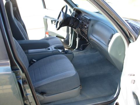 1997 Ford Explorer - The interior of a vehicle shows the front seats, dashboard, and center console area.