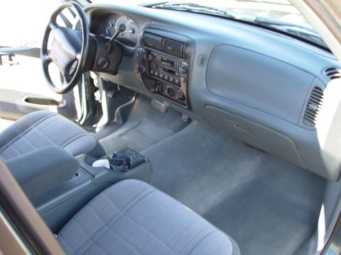 1997 Ford Explorer - The interior of a 1997 Ford Explorer is visible, gray cloth seats and a full dashboard.