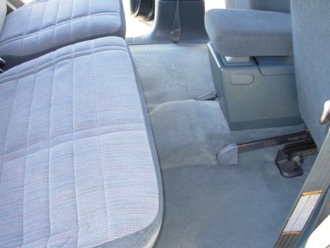 1997 Ford Explorer - The interior of a 1997 Ford Explorer shows blue patterned seats and a center console.