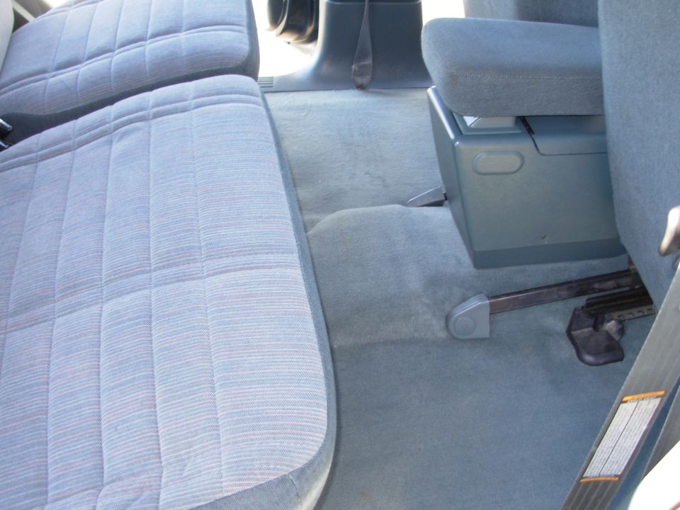 1997 Ford Explorer interior with blue patterned seats, center console, and floor mats