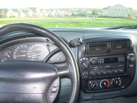 1997 Ford Explorer - The interior of a 1997 Ford Explorer, the dashboard with radio and climate controls.