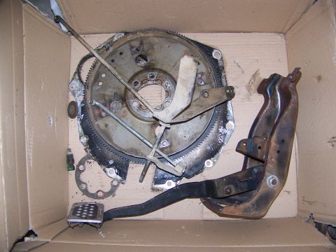 1992 Jeep YJ - Clutch pedal assembly and flywheel are shown inside a cardboard box.