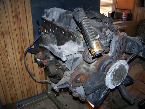 1992 Jeep YJ - Engine assembly shown on a stand, various components like the fan and hoses.