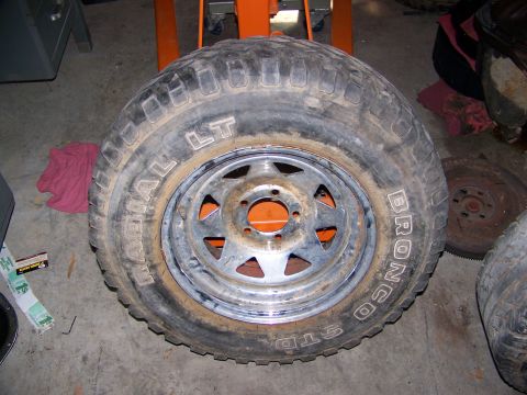1992 Jeep YJ - A close-up view of a single tire and wheel assembly, with text visible on the tire's sidewall.