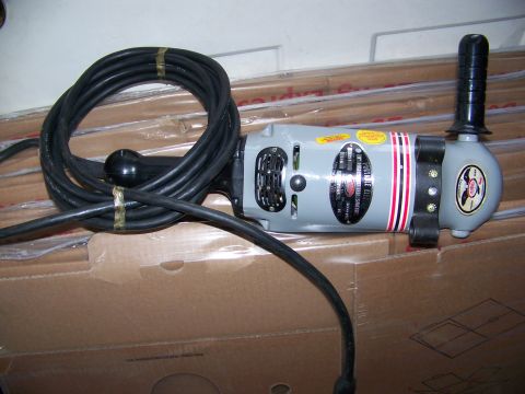 1992 Jeep YJ - An electric grinder with a coiled black cord and a black handle is shown, resting on cardboard boxes.