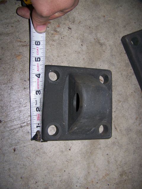 1992 Jeep YJ - A black metal part is being measured with a tape measure, showing its dimensions.