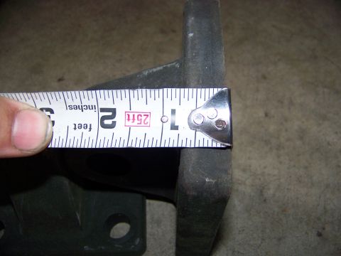 1992 Jeep YJ - A tape measure is used to determine the dimensions of a dark-colored metal component.