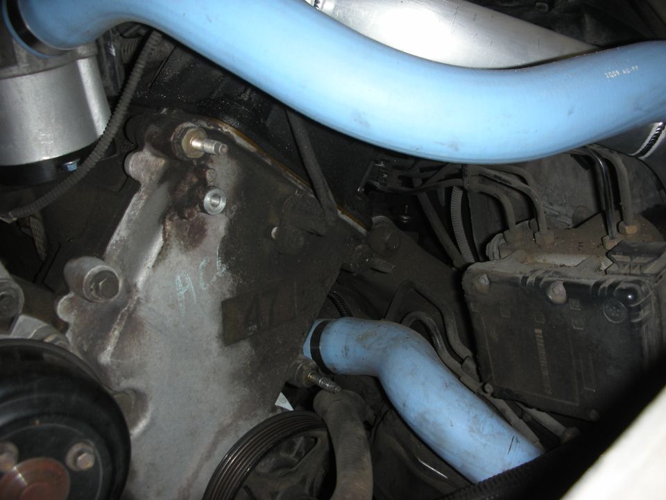 Engine front with number 47 cast on housing and light blue coolant hoses