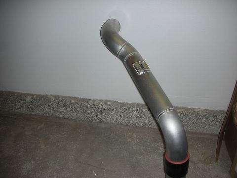 1998 Ford Crown Victoria - S-shaped mandrel-bent aluminum pipe with a welded mounting tab, leaning upright against a basement wall.
