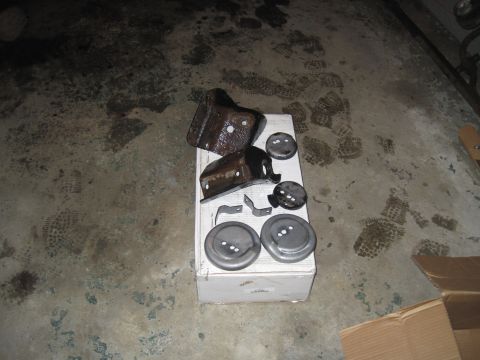 1979 Ford Bronco - A collection of assorted suspension components are displayed on a white box on a concrete floor.