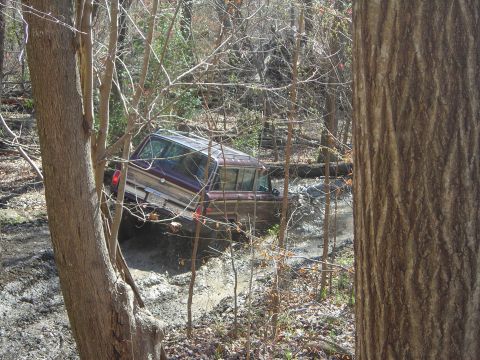 1995 Ford Bronco - This 1995 Ford Bronco is stuck in the mud while off-roading through a wooded area.