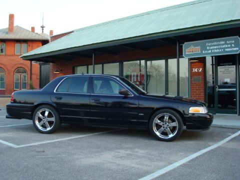 2004 Ford Crown Victoria - A black 2004 Ford Crown Victoria is parked outside the Fayetteville Area Transportation & Local History Museum.
