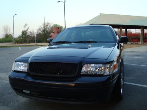 2004 Ford Crown Victoria - Front view of a black 2004 Ford Crown Victoria parked in a lot.