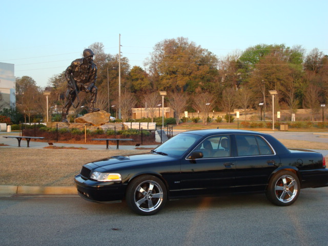 Black 2004 Ford Crown Victoria parked by a statue