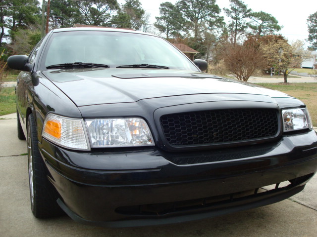 Front view of a black 2004 Ford Crown Victoria with a honeycomb grille