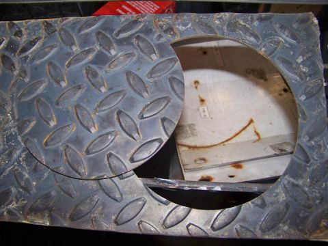 1989 Ford Bronco - Close-up of a diamond plate access panel, revealing rust and metal underneath.