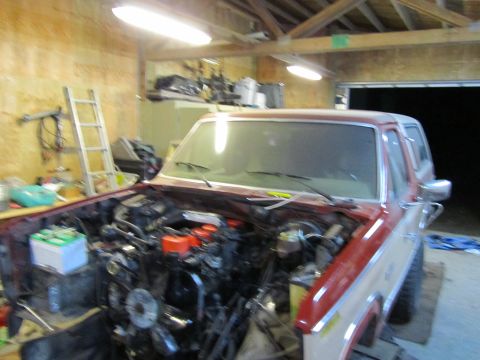 1984 Ford Bronco - Ford Bronco in garage, engine bay is empty, ready for work.