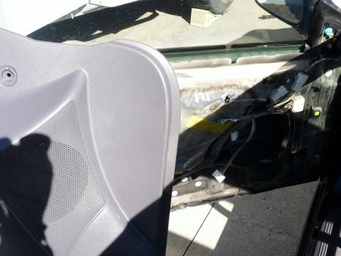 2006 Ford E350 - Interior of a car door with the panel removed, exposing wiring and mechanisms.