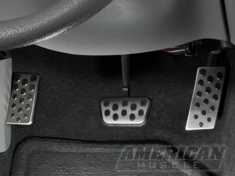 1990 Ford Bronco - Aftermarket pedal covers installed on the driver's side floor of a vehicle.