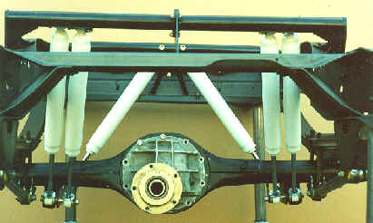 1990 Ford Bronco - Close-up view of a vehicle's rear axle and suspension system components.
