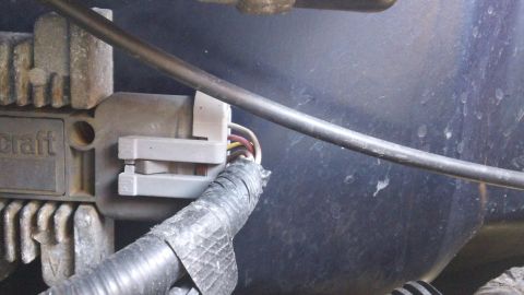 1994 Ford Bronco - A close-up view of an electrical connector and its wiring harness, likely part of a vehicle's engine compartment.