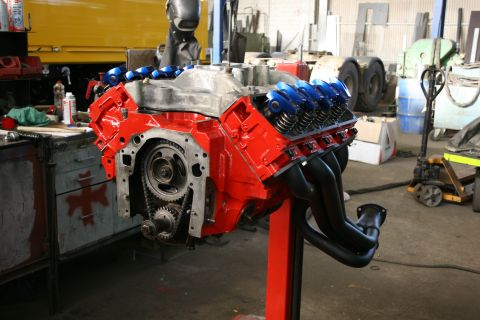 1973 Ford Ranchero - V8 engine on a stand in a workshop, likely undergoing rebuild or modification.