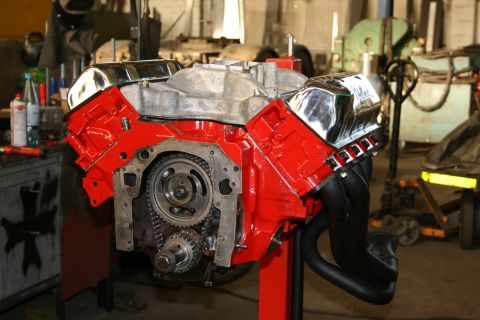 1973 Ford Ranchero - A red Ford V8 engine, likely a 400 cubic inch, is displayed on a stand with its timing chain visible.