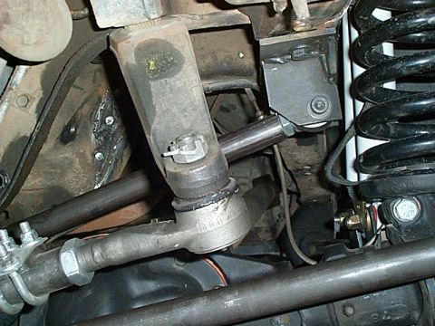 1994 Ford Bronco - Detail view of the steering and suspension system of an off-road vehicle.