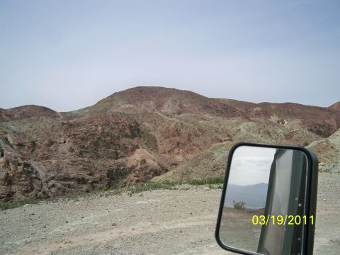 1992 Jeep Wrangler - A side mirror reflects a desert landscape with mountains and a date stamp of March 19, 2011.