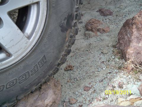 1992 Jeep Wrangler - A vehicle's tire rests on uneven, rocky terrain. The date stamp 03/19/2011 is visible in the lower right corner.