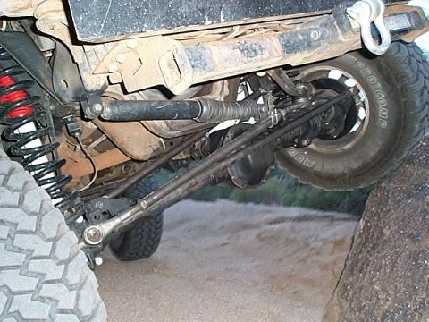 1994 Ford Bronco - Close-up view of the modified suspension and drivetrain of an off-road vehicle.