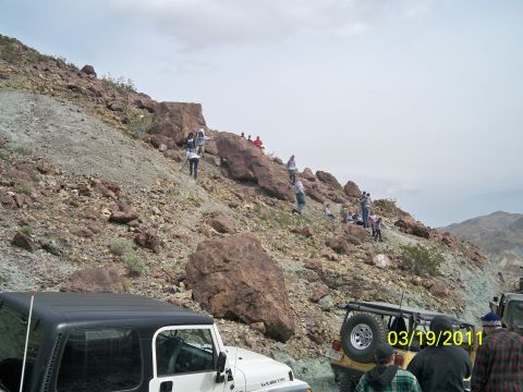 1992 Jeep Wrangler - People explore a rocky hillside with several Jeeps parked nearby.