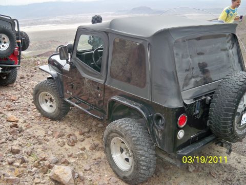 1992 Jeep Wrangler - A black Jeep Wrangler is parked on a rocky trail with a second Jeep in the background. The date 03/19/2011 is visible.
