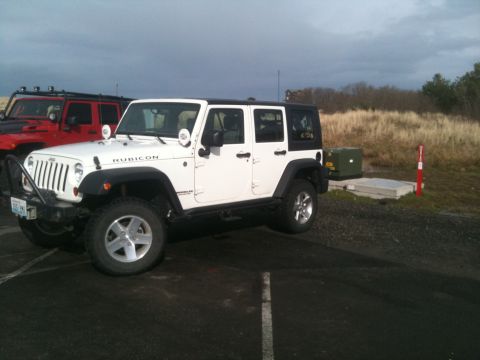 2005 Jeep Wrangler - Two Jeep Wranglers are parked outdoors under a cloudy sky.