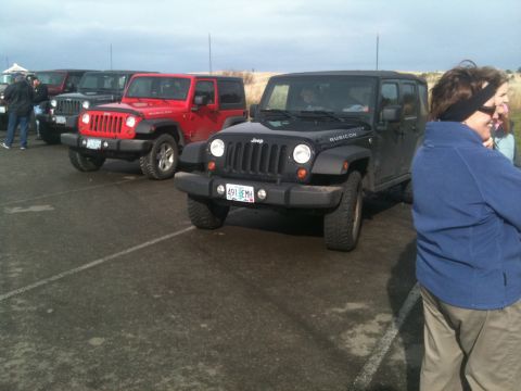 2005 Jeep Wrangler - A black Jeep Wrangler, identified as a Rubicon model, is parked in a lot with other vehicles. The license plate is visible.