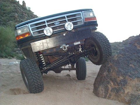 1994 Ford Bronco - This 1994 Ford Bronco navigates a rocky trail with its front wheels elevated.
