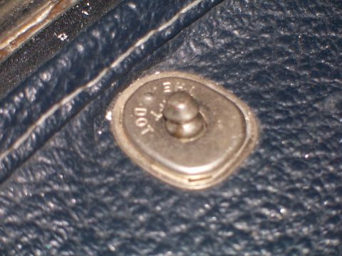1973 Ford Ranchero - A close-up view of a vehicle's interior door latch mechanism, showing some visible text.