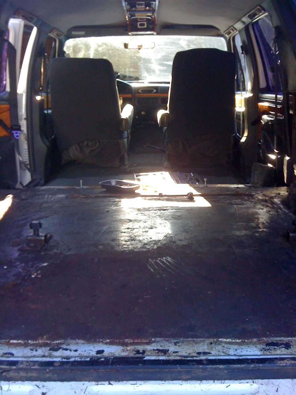 1992 Ford C-350 (Centurion Conversions) interior showing two front seats, bare floor, and overhead console