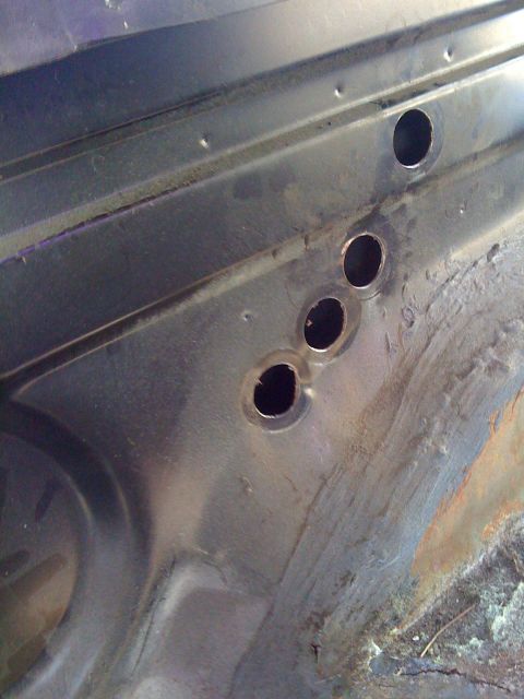 1992 Ford C-350 (Centurion Conversions) - This image shows a section of metal with several holes drilled into it, likely part of a vehicle's interior structure.