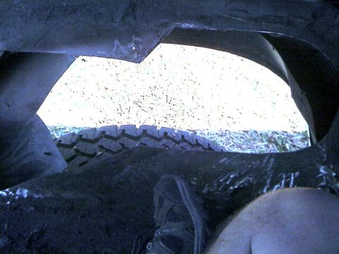 1992 Ford C-350 (Centurion Conversions) - View from inside the wheel well shows the tire and the underside of the vehicle.