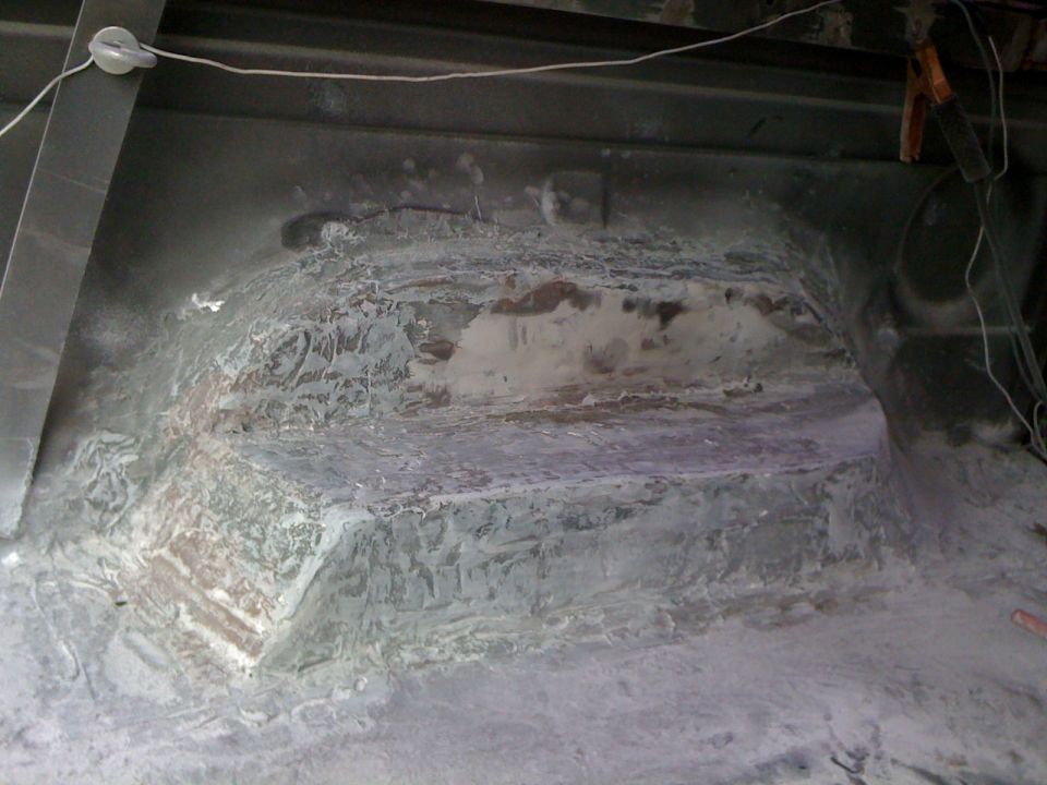 Interior wheel well area with visible repair work and wiring
