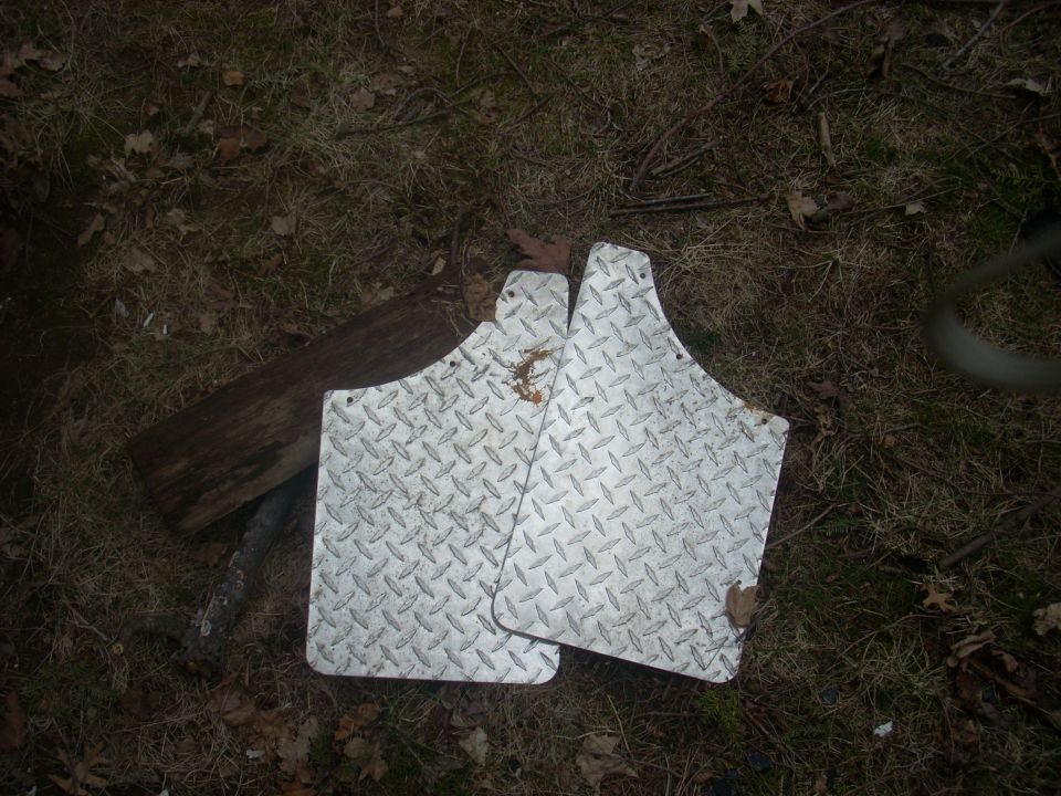 Pair of diamond plate mud flaps on the ground