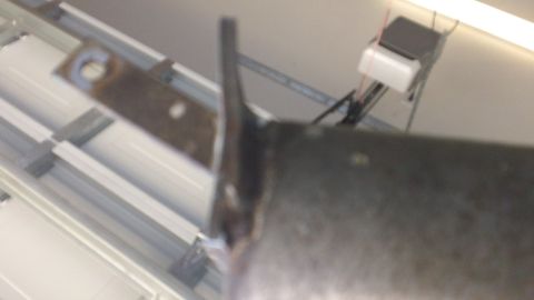 1994 Ford Bronco - Metal bracket with mounting hole, attached to a pipe.