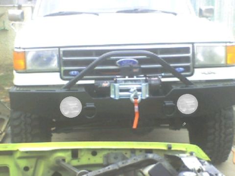 1989 Ford Bronco - Front view of a white Ford truck a winch and brush guard, identified by its 1987 grille.