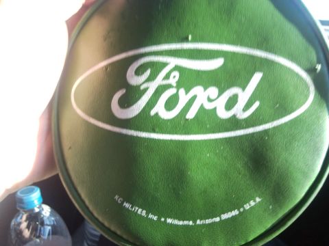 1989 Ford Bronco - This is a Ford logo on a green cover, possibly for a spare tire or accessory.