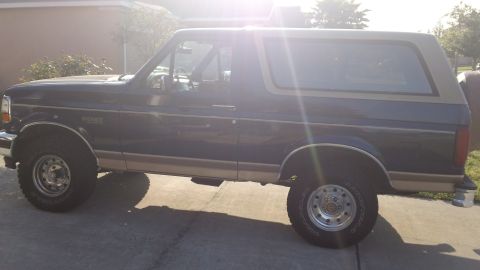 1994 Ford Bronco - This 1994 Ford Bronco is shown from the side, a two-tone paint scheme of dark blue and tan.