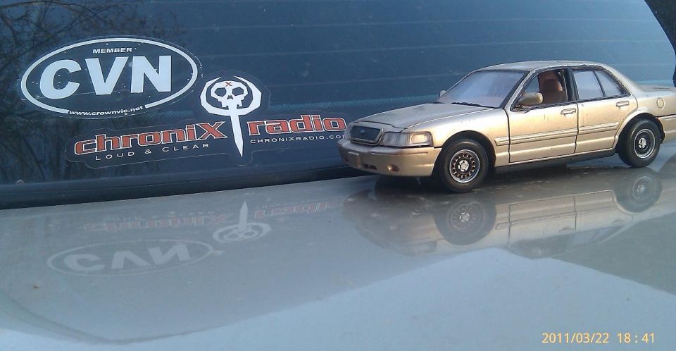 Toy car with stickers on the window behind it